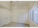 A bedroom with light colored walls, gray tile flooring, and two closets at 1409 E Goldenrod St, Phoenix, AZ 85048