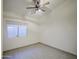 A small bedroom with a fan and window at 1409 E Goldenrod St, Phoenix, AZ 85048