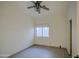 An empty bedroom that has a fan and a small window at 1409 E Goldenrod St, Phoenix, AZ 85048