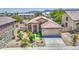 Beautiful aerial shot of the home, landscaped front yard, and two-car garage, in a well-maintained community at 1409 E Goldenrod St, Phoenix, AZ 85048