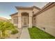 Inviting front entrance features a security door, desert landscaping, and green grass turf at 1409 E Goldenrod St, Phoenix, AZ 85048