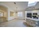 Open-concept kitchen featuring a granite island, modern appliances, and sunlit windows at 1409 E Goldenrod St, Phoenix, AZ 85048