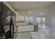 Kitchen with white cabinets, granite counters, stainless appliances, tile backsplash, and tile floors at 1409 E Goldenrod St, Phoenix, AZ 85048