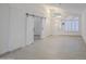 Bright living room with tile flooring, plantation shutters, and stylish barn doors at 1409 E Goldenrod St, Phoenix, AZ 85048
