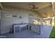 Spacious covered patio featuring a built-in outdoor kitchen with a sink, grill, and storage at 1409 E Goldenrod St, Phoenix, AZ 85048