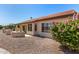 Charming backyard featuring a built-in grill, covered patio, and attractive desert landscaping at 15011 W Verde Ln, Goodyear, AZ 85395