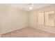 Standard bedroom with light carpet and a ceiling fan at 15011 W Verde Ln, Goodyear, AZ 85395