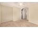 Bedroom featuring neutral tones, light carpet, and an archway to other rooms at 15011 W Verde Ln, Goodyear, AZ 85395
