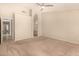 Neutral primary bedroom with carpet flooring, en suite bathroom, and ceiling fan at 15011 W Verde Ln, Goodyear, AZ 85395