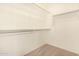 Walk-in closet featuring carpeted flooring and metal rod shelving at 15011 W Verde Ln, Goodyear, AZ 85395