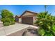 Well-maintained home with a two-car garage and desert landscaping at 15011 W Verde Ln, Goodyear, AZ 85395