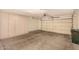 Garage interior with built-in storage and a roll up door at 15011 W Verde Ln, Goodyear, AZ 85395