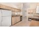 Charming kitchen featuring tile floors and stainless steel dishwasher and light wood cabinetry at 15011 W Verde Ln, Goodyear, AZ 85395