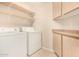Laundry room featuring cabinets and a tile floor at 15011 W Verde Ln, Goodyear, AZ 85395