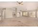 Open concept living room with kitchen bar and tile/carpet flooring at 15011 W Verde Ln, Goodyear, AZ 85395