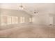 Bright living room featuring neutral colors, fan, and natural light at 15011 W Verde Ln, Goodyear, AZ 85395
