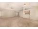 Spacious open-concept living room with bar and carpet flooring at 15011 W Verde Ln, Goodyear, AZ 85395