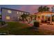 Lush backyard with a pool, spa, fire pit, manicured lawn, and mature palm trees at 16178 W Granada Rd, Goodyear, AZ 85395