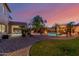 Expansive backyard featuring a pool, spa, lush landscaping, and outdoor seating areas at 16178 W Granada Rd, Goodyear, AZ 85395