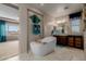 Bathroom featuring soaking tub with modern fixtures and stylish decor at 16178 W Granada Rd, Goodyear, AZ 85395