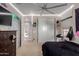 A cozy bedroom with neutral tones, featuring ample closet space, ceiling fan, and carpeted floors at 16178 W Granada Rd, Goodyear, AZ 85395