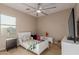 Bright bedroom with a ceiling fan, carpeted floors, and natural light creating a comfortable atmosphere at 16178 W Granada Rd, Goodyear, AZ 85395