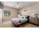 Well-lit bedroom featuring a ceiling fan, wall decor, and bright windows at 16178 W Granada Rd, Goodyear, AZ 85395