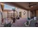 Spacious covered patio with ceiling fan, a lounge area, and fire pit perfect for entertaining guests outdoors at 16178 W Granada Rd, Goodyear, AZ 85395