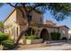 Charming two-story home showcasing mature landscaping, terracotta tile roof, and an arched entryway at 16178 W Granada Rd, Goodyear, AZ 85395