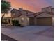 Beautiful two-story home featuring a terracotta tile roof, arched entryway, and a large two-car garage at 16178 W Granada Rd, Goodyear, AZ 85395