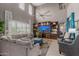 Open-concept living room boasts vaulted ceilings, a built-in entertainment center and ample seating space at 16178 W Granada Rd, Goodyear, AZ 85395