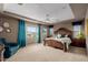 This spacious bedroom features an elegant tray ceiling, fan and large windows at 16178 W Granada Rd, Goodyear, AZ 85395