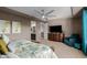 Luxurious main bedroom featuring a tray ceiling, a sitting area, and an ensuite bathroom at 16178 W Granada Rd, Goodyear, AZ 85395