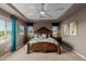 Elegant main bedroom with a decorative headboard, stylish window treatments, and ample natural light at 16178 W Granada Rd, Goodyear, AZ 85395