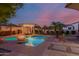 Beautiful pool area with a fountain, spa, fire feature, and seating under a pergola at 16178 W Granada Rd, Goodyear, AZ 85395