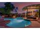 Beautiful pool with a water feature, fire pit, and lounge chairs under a pergola for relaxation at 16178 W Granada Rd, Goodyear, AZ 85395