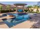 Sparkling pool with a pergola-covered lounge area and a fire pit, surrounded by lush landscaping, creating a relaxing oasis at 16178 W Granada Rd, Goodyear, AZ 85395
