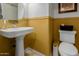 Charming powder room featuring a pedestal sink, stylish fixtures, and a comfortable layout at 16178 W Granada Rd, Goodyear, AZ 85395