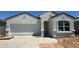 Charming one-story home with a two-car garage and modern stucco exterior at 18340 W Hackamore Dr, Wittmann, AZ 85361