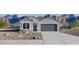 Inviting single-story home with a tidy front yard and mountain views in the distance at 18340 W Hackamore Dr, Wittmann, AZ 85361