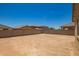 The backyard features a blank canvas and is surrounded by privacy walls for custom landscaping at 18365 W Villa Hermosa Ln, Surprise, AZ 85387