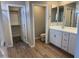 Bathroom featuring double sinks, vanity, and entry to a walk-in closet at 18365 W Villa Hermosa Ln, Surprise, AZ 85387