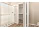 Modern bathroom featuring a glass-enclosed shower and wood-look tile flooring at 18365 W Villa Hermosa Ln, Surprise, AZ 85387