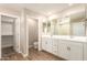 Bathroom boasting dual vanities, tile floors, and access to the walk-in closet at 18365 W Villa Hermosa Ln, Surprise, AZ 85387