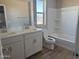 Bright bathroom with double sink vanity, bathtub and shower combo, and a window at 18365 W Villa Hermosa Ln, Surprise, AZ 85387