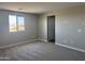 Spacious carpeted bedroom featuring a large window and neutral walls at 18365 W Villa Hermosa Ln, Surprise, AZ 85387