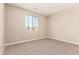 Bedroom features neutral carpet, one large window and light-colored walls at 18365 W Villa Hermosa Ln, Surprise, AZ 85387