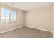 This bedroom has neutral carpeting, a window, and plenty of wall space for decor at 18365 W Villa Hermosa Ln, Surprise, AZ 85387