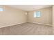 Spacious bedroom with neutral carpet, light-colored walls, and abundant natural light at 18365 W Villa Hermosa Ln, Surprise, AZ 85387