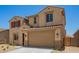 Two-story tan stucco home with red shutters, tile roof, and a two-car garage at 18365 W Villa Hermosa Ln, Surprise, AZ 85387